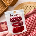Close-up of three red velvet and knit bow hair clips on a decorative bunny card - Red Polka Dot & Button Set 3Pcs