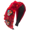 Detail of red velvet Halloween headband with skull motifs and rose rhinestone decorations - Red