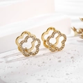 Macro shot of 18K gold plated floral earrings with sparkling white crystals and petals - Ear Buckle / Gold White Flower