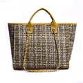 Close-up of yellow tweed tote bag showing textured weaving and leather chain handles - Yellow