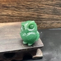 Close-up of a 3.5cm hand-carved green jade owl figurine with smooth natural stone texture - Green Aventurine