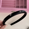 Close-up of black satin headband with silver metal bows on a pink jewelry box background - Headband / Black (Silver Bow)