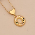 Detail view of a gold doughnut pendant with colorful zircons and heart clasp - Letter O / Gold