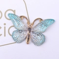 Macro detail of gradient blue and purple resin butterfly pendant with gold plated edges - 8 Lake Blue