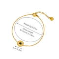 Detail of 18K gold-plated steel bracelet with sunburst disc pendant and emerald center - Disk Sun Pattern Black Bead - Bracelet 13