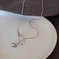 Minimalist silver bead slider necklace with geometric abstract ring on a fabric surface - Silver Adjustable Pull
