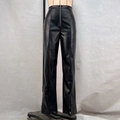 Close-up of black high-waisted faux leather pants featuring a front zipper and side slit hems - S / Black