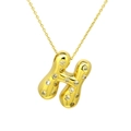 Close-up of golden balloon letter H pendant necklace with sparkly inlaid zircons - Letter H / Gold