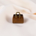Miniature tiger eye stone handbag pendant with golden metal handle on beige fabric - Tiger's Eye