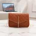 Quilted brown crossbody bag with gold chain strap and decorative tassel charm - Brown