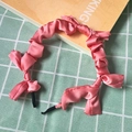 Detailed view of pink satin pleated headband with a silky finish and rippled design - Pink (Satin)