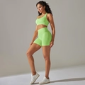 Close-up of neon green ribbed seamless yoga set showing high waist shorts and bra detail - Cyan