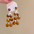 Detail shot of brown flocked circular earrings with silver needles held in hand - Silver Bead Style (104#) / Silver Brown