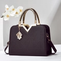 Women's black faux leather handbag with geometric texture and gold V-shaped handles - Coffee