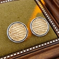 Detail of vintage round gold earrings with horizontal texture in a wooden frame - Gold/White