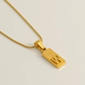 Golden stainless steel necklace featuring a textured square pendant with relief letter W - Letter W