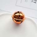 Polished bronze star cutout metal bell on white ceramic for DIY Christmas crafts - 40mm / Orange