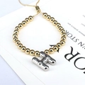 Detail of beaded gold bracelet with silver balloon H pendant and adjustable chain - Letter H