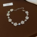 Detailed view of silver flower bracelet with sparkling zircons and lobster clasp closure - Silver