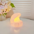 Cartoon animal vinyl night light in warm yellow glow on a white table decoration - Baby Pink