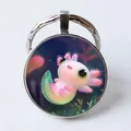 Silberner runder Schlüsselanhänger mit pinkem Axolotl auf dunkelblauem Grund - Cartoon Axolotl