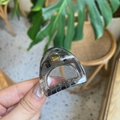 Detail of a translucent smoke grey resin hair claw clip with strong gold metal spring - Mini Cat Ear / Transparent Black