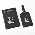 Close-up of black PU leather passport holder and luggage tag set with gold letter E - Black Letter E