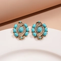 Macro detail of vintage gold-tone earrings with turquoise resin and sparkling crystals - Silver Needle Earrings-Blue