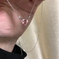 Silver necklace featuring a faceted pink heart gemstone pendant held in hand - Pink Zircon Heart Necklace
