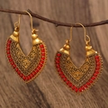 Detail of bohemian hollow engraved gold earrings with red braided cord on wooden branch - Antique Gold G-325