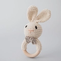 Handmade crochet bunny baby rattle with natural wooden ring and a beige knit design - Bowtie Rabbit
