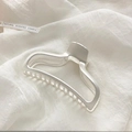 Matte silver hollow geometric metal hair claw clip for women on white fabric background - Matte Silver Metal Claw