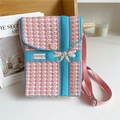 Close-up of pink and blue houndstooth knit mini bag with white bow and SPACE label detail - Bow Houndstooth Pink