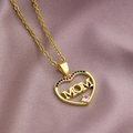 Close-up of golden MOM heart pendant with colorful zircon stones on purple satin - Heart MOM-Pink Zircon Accent