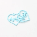 Macro shot of light blue heart pendants with hollow flame pattern for DIY jewelry - Blue