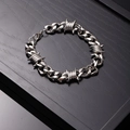Silver Cuban link bracelet with barbed wire design on black wood display tray - 22cm / Silver Bracelet
