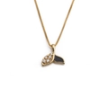 Detailed macro shot of a gold fishtail pendant with black enamel and zircon stones - Black