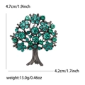 Macro view of tree of life brooch with green rhinestones showing 4.7cm size details - Green