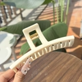 Creamy white 13.5cm oversized hair claw clip held outdoors with natural lighting - Greek-letter Shaped Extra Large Butterfly Buckle / Solid White (Approx 13.5cm)