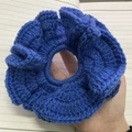 Detail of blue crochet ruffle hair tie showing handmade knit texture and flower design - Blue