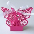 Close-up of pink laser-cut butterfly candy box with a delicate white ribbon tie - Pearlescent Magenta with Ivory Ribbon