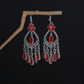 Detail of bohemian red drop earrings with intricate silver filigree on a dark branch - Red Flower Teardrop Dangle Style (E6142-1)