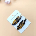 Detailed view of two tortoiseshell patterns acetate hair clips on white card packaging - Acetate Dark Leopard 1 Pair