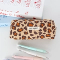 Detail of leopard print corduroy pencil case with woven brand logo in a desk scene - Yellow Large Leopard