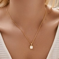 Elegant 18K gold plated necklace with round shell pendant shown on a female model - KN0458-Oval White Gemstone