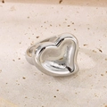 Polished silver heart-shaped stainless steel wide ring on a textured stone surface - 18mm Steel Full Heart Style