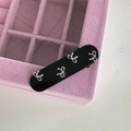 Detail of a black hair clip with four silver metal bows on a pink velvet jewelry box - Duckbill Hair Clips / Black (Silver Bow)