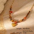 Detail of bohemian necklace with tiger eye beads and heart pendant on sand background - Irregular Natural Stone (LC40054)