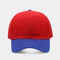 Detail of a six-panel baseball cap showing red crown and blue brim contrast stitching - Bright Red + Royal Blue Brim
