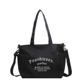 Bolso tote de lona negra con bolsillos laterales y correa ajustable para mujer - Negro